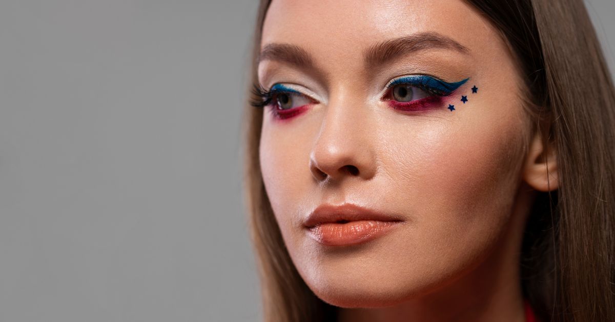 A woman adorned with striking blue and red eye shadow palette, emphasizing her unique and creative appearance.