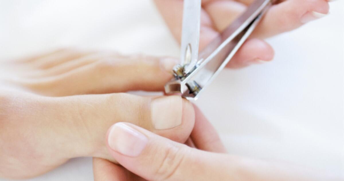 Close-up of professional toe nail clippers cutting thick toenails, designed for precision and durability